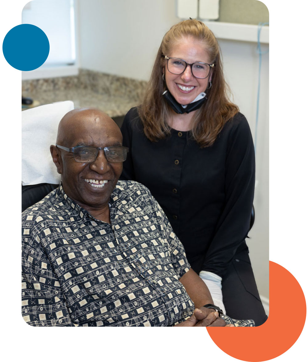 Smiling adult patient with a Hayden Dental Group team member