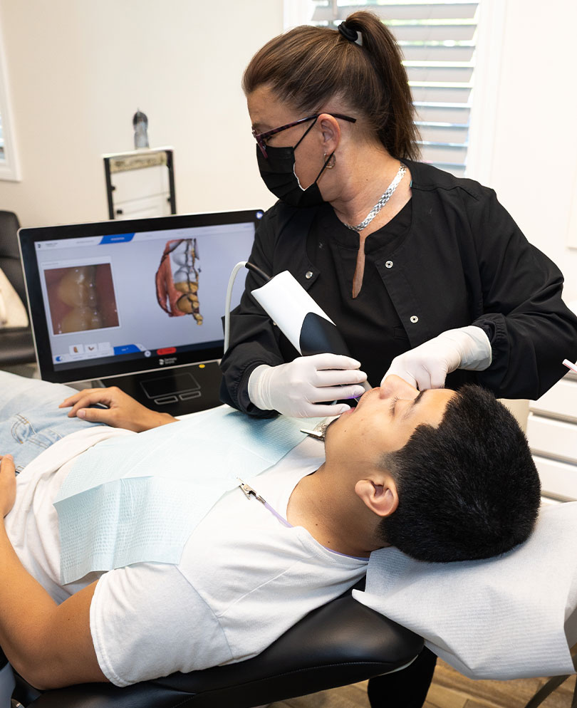 Dental professional using an intraoral scanner on a patient