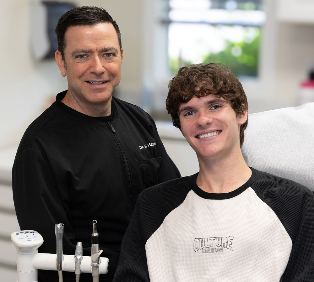 Dr. Joel Hayden with a smiling dental patient during a teeth whitening visit